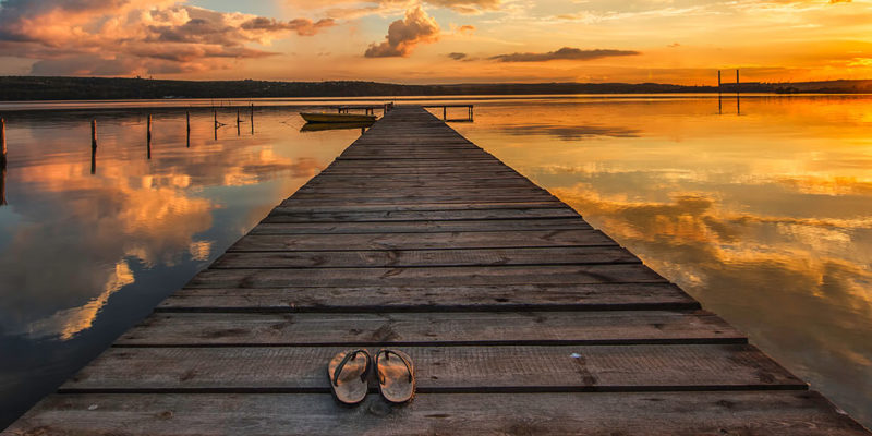 flip flops on dock at sunset